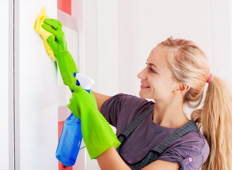 Cleaning technician preparing carpet cleaning equipment safely